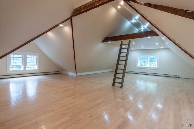 additional living space featuring baseboard heating, a baseboard radiator, vaulted ceiling with beams, and wood finished floors