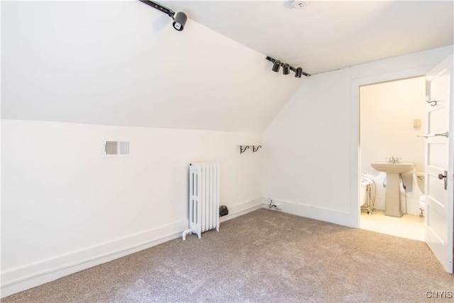 bonus room with visible vents, light carpet, a sink, radiator heating unit, and lofted ceiling