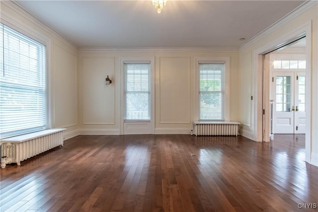 unfurnished room with dark wood-type flooring, a decorative wall, and radiator