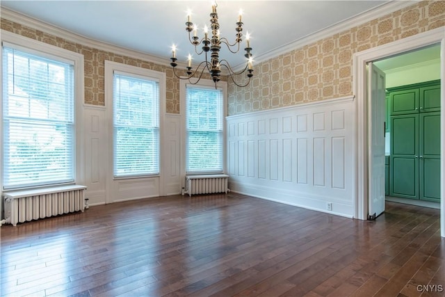 unfurnished dining area featuring a wainscoted wall, radiator heating unit, and wallpapered walls