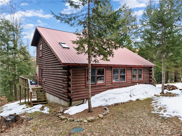 view of snowy exterior featuring a deck