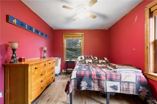 bedroom with light hardwood / wood-style flooring and ceiling fan