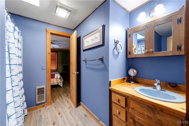 bathroom with vanity and wood-type flooring