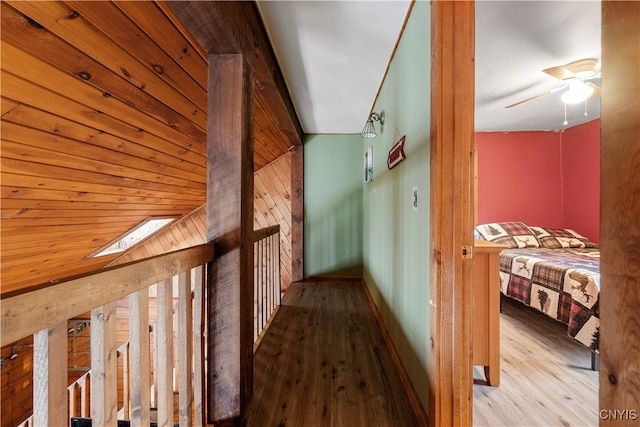 corridor featuring a skylight and light hardwood / wood-style floors