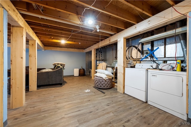 basement featuring hardwood / wood-style flooring and washer and clothes dryer