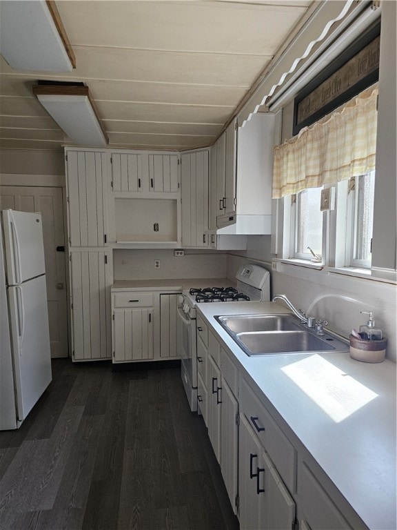 kitchen with white appliances, dark hardwood / wood-style flooring, white cabinetry, and sink