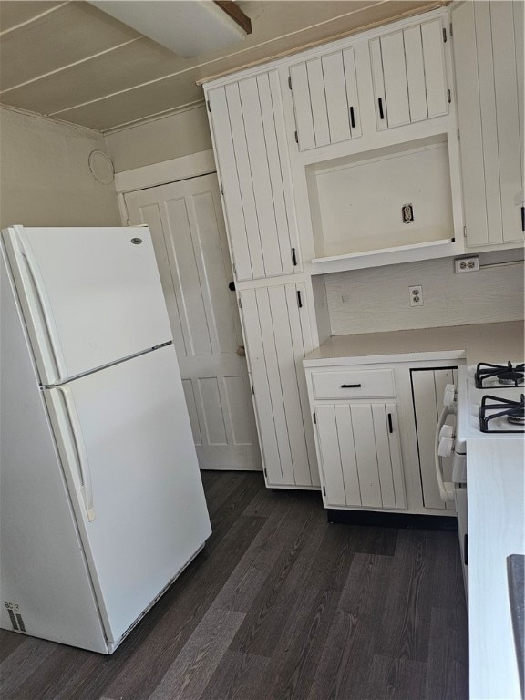 kitchen featuring dark wood-type flooring, white appliances, and white cabinetry