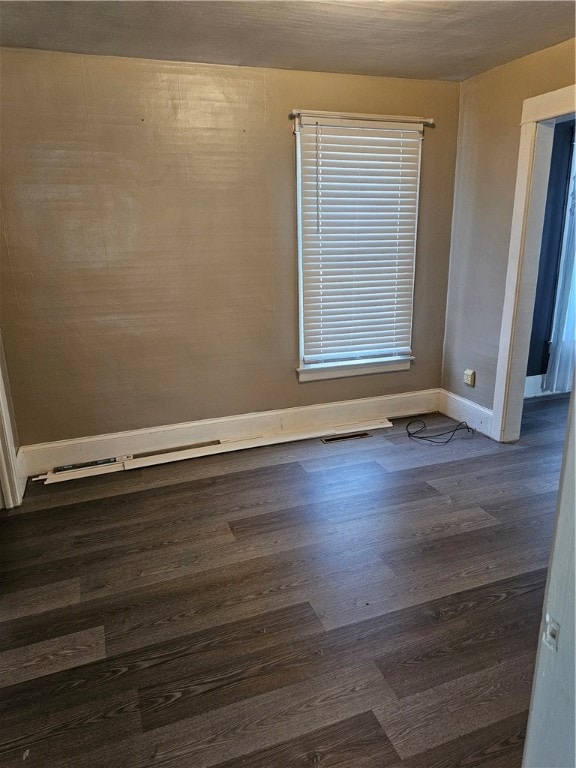 spare room with dark wood-type flooring