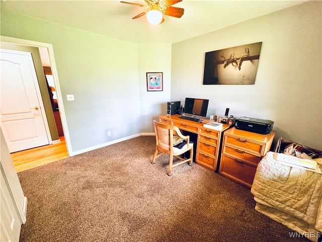 office space with ceiling fan and dark colored carpet