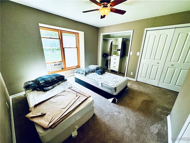 carpeted bedroom featuring ceiling fan, cooling unit, and two closets