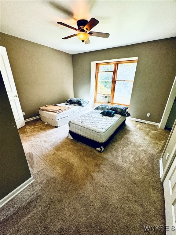 unfurnished bedroom featuring cooling unit, carpet flooring, and ceiling fan