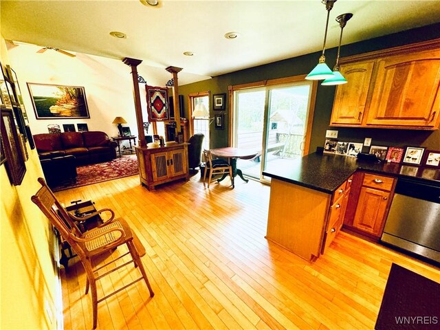 kitchen with ceiling fan, pendant lighting, stainless steel dishwasher, a center island, and light hardwood / wood-style floors