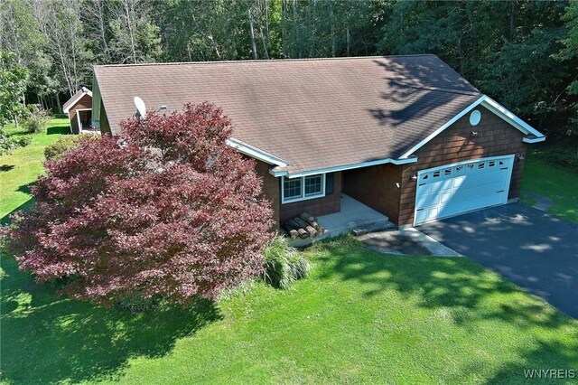 view of front of property with a garage and a front lawn