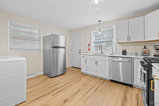 kitchen featuring light wood-type flooring, stainless steel appliances, white cabinetry, and sink