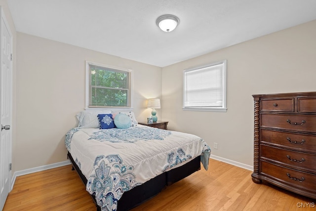 bedroom with light hardwood / wood-style flooring and multiple windows