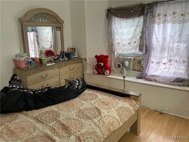 bedroom featuring light hardwood / wood-style floors and multiple windows