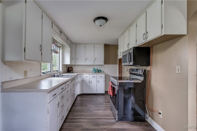 kitchen featuring black / electric stove, dark hardwood / wood-style flooring, and white cabinetry