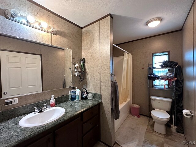 full bathroom featuring a textured ceiling, vanity, shower / bath combination with curtain, crown molding, and toilet