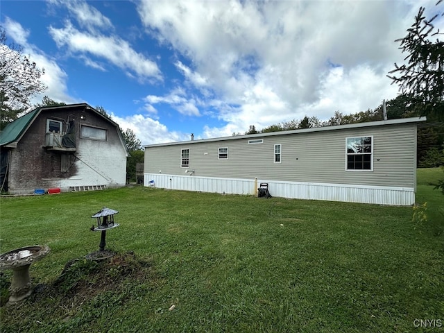 rear view of house with a yard and central AC unit