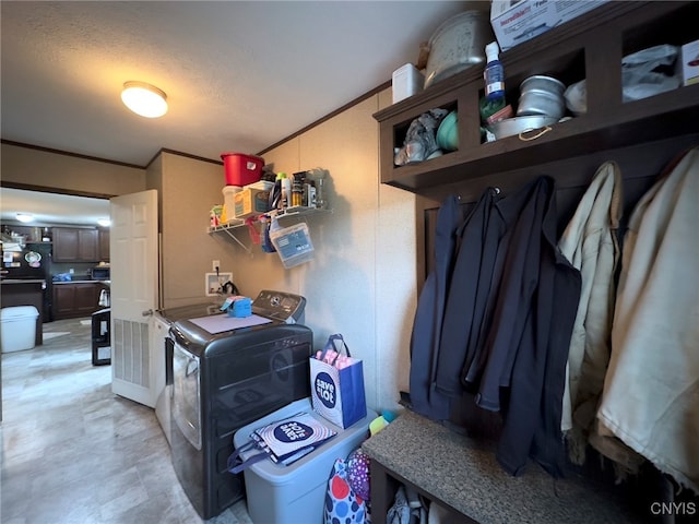 laundry area featuring washer and dryer, crown molding, and a textured ceiling