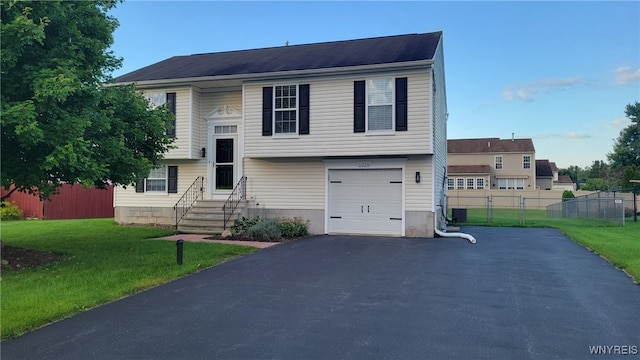 view of front of house with a front yard and a garage