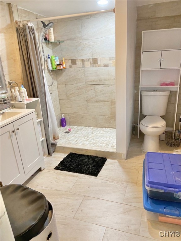 bathroom with toilet, vanity, and curtained shower