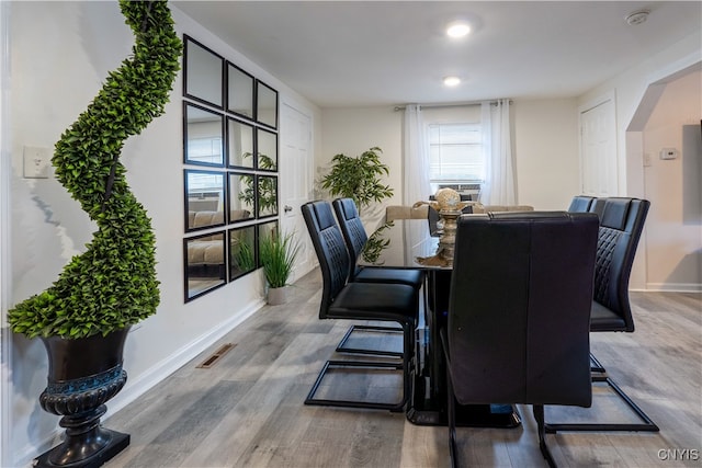 dining area with hardwood / wood-style floors