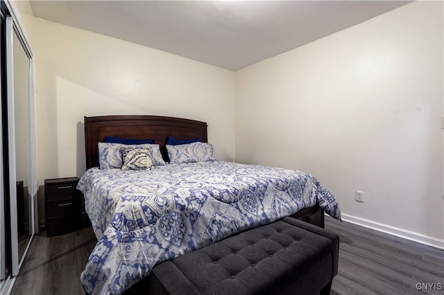 bedroom featuring a closet and dark hardwood / wood-style floors