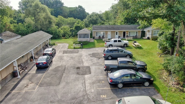 view of front of property with a front yard and uncovered parking