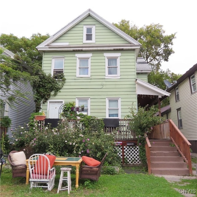 back of property with a wooden deck