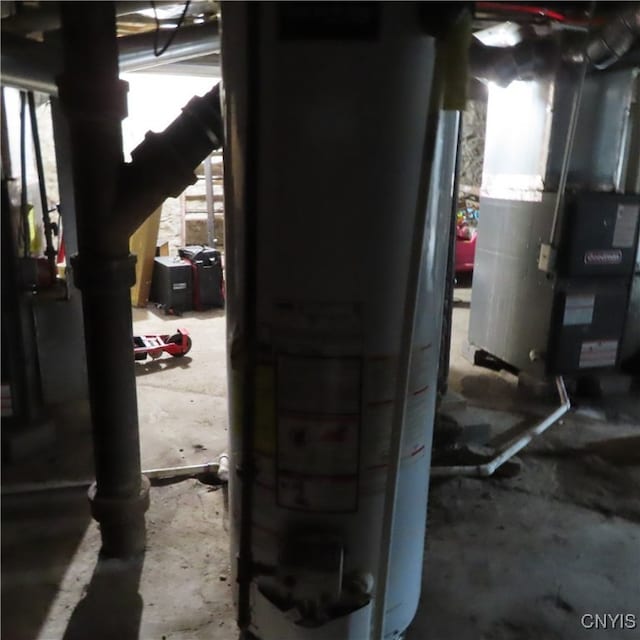 utility room with water heater and heating unit