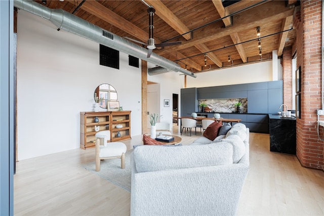 living room with wood ceiling, beam ceiling, ceiling fan, and light hardwood / wood-style floors