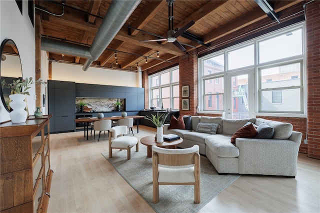 living room with wood ceiling, brick wall, ceiling fan, and light hardwood / wood-style floors