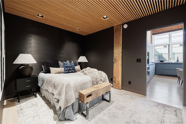 bedroom featuring hardwood / wood-style floors and wooden ceiling