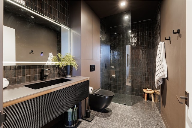 bathroom featuring vanity, toilet, and a tile shower