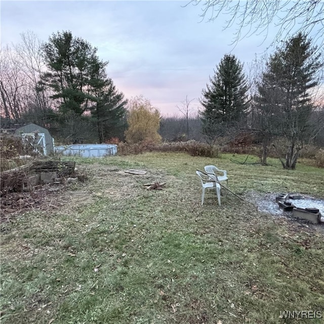 yard at dusk with a storage shed