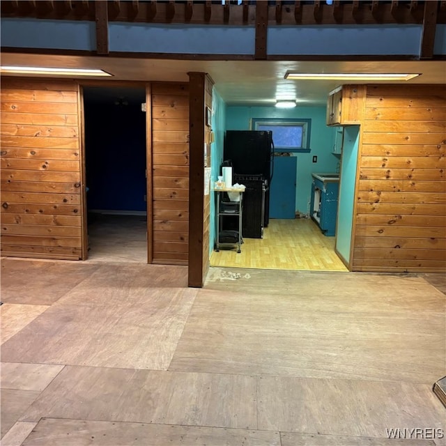 interior space featuring wood walls and light wood-type flooring