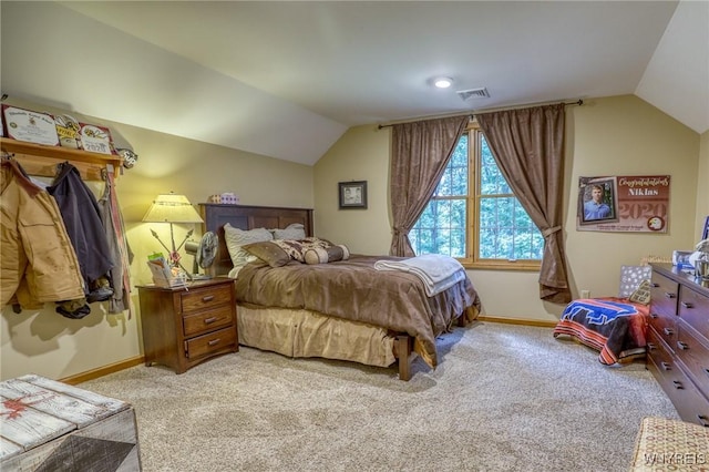 bedroom featuring light carpet and vaulted ceiling