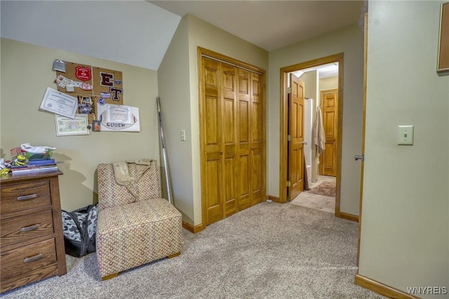 living area featuring light carpet