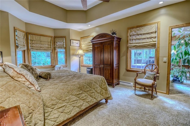 bedroom with ceiling fan, carpet floors, and a baseboard radiator