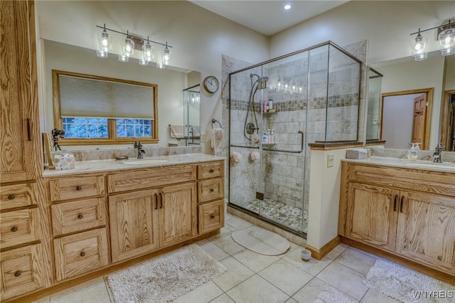 bathroom featuring vanity, tile patterned floors, and a shower with door