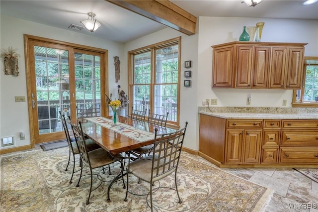 dining room featuring beamed ceiling