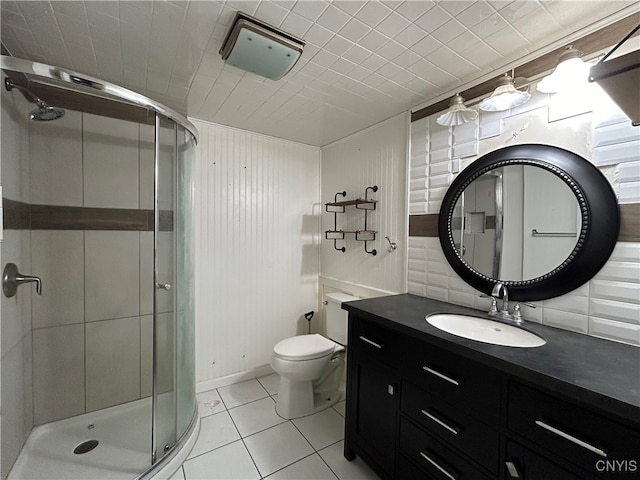 bathroom featuring a shower with door, vanity, toilet, and tile patterned flooring