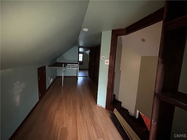 bonus room with lofted ceiling and light hardwood / wood-style floors