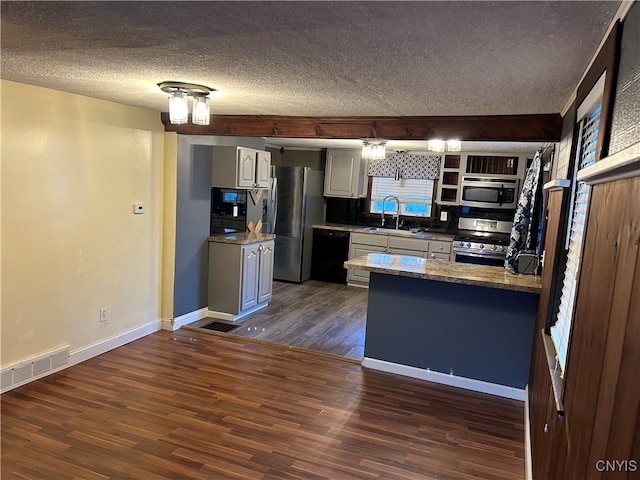 kitchen featuring sink, a textured ceiling, white cabinetry, stainless steel appliances, and dark wood-type flooring