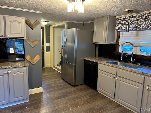 kitchen featuring black dishwasher, sink, and a textured ceiling