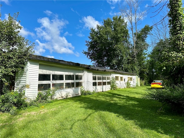 rear view of house featuring a lawn