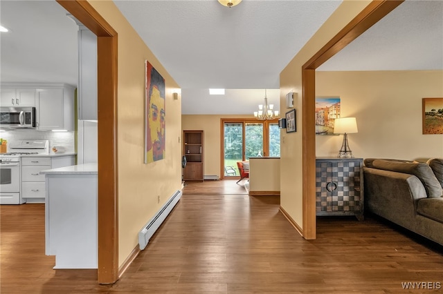 hall featuring a chandelier, a baseboard radiator, and light hardwood / wood-style floors