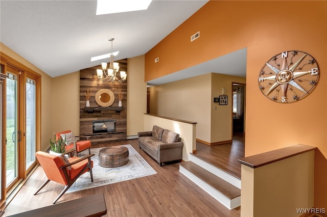 living room with vaulted ceiling, wood walls, a chandelier, hardwood / wood-style flooring, and a multi sided fireplace