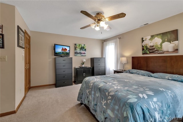 bedroom with light colored carpet and ceiling fan